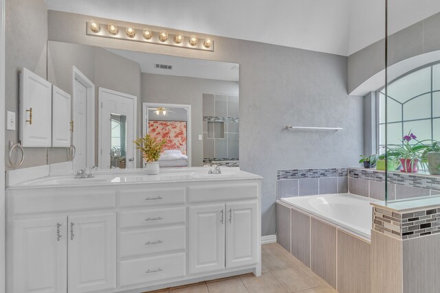 4001 Elmhill Dr, Plano, TX 75024 - bathroom with double vanity, tile patterned flooring, a bath, and ceiling fan
