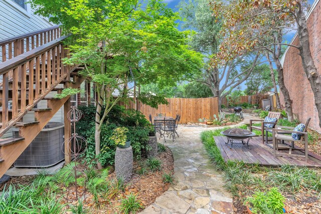 4001 Elmhill Dr, Plano, TX 75024 - fenced backyard with an outdoor fire pit, a deck, central AC unit, a patio, and stairs
