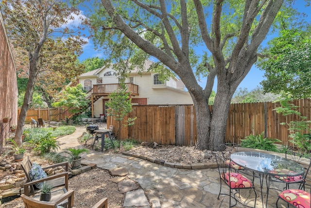 4001 Elmhill Dr, Plano, TX 75024 - fenced backyard featuring a patio area, outdoor dining space, stairs, and a wooden deck