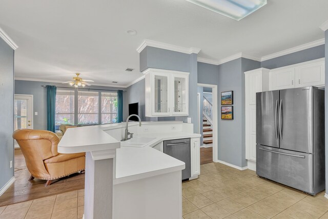 4001 Elmhill Dr, Plano, TX 75024 - kitchen featuring stainless steel appliances, a sink, a peninsula, glass insert cabinets, and light countertops