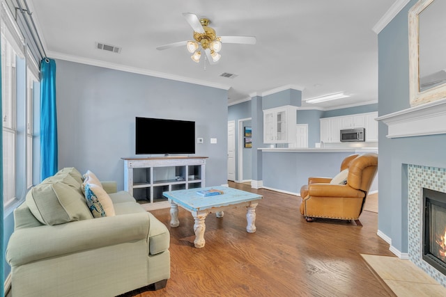 4001 Elmhill Dr, Plano, TX 75024 - living area featuring a fireplace, ceiling fan, wood finished floors, ornamental molding, and baseboards