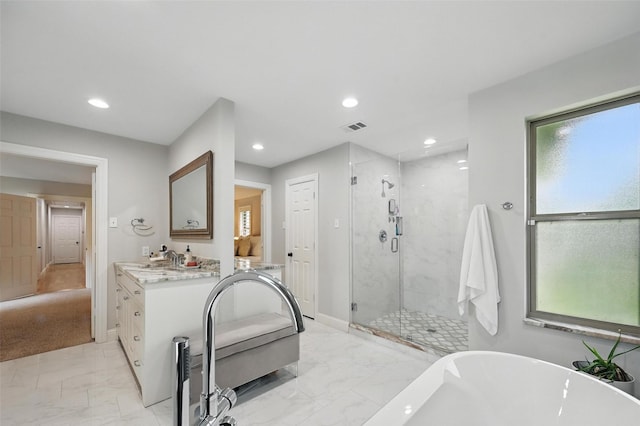 16905 Colegrove Dr, Dallas, TX 75248 - full bath with marble finish flooring, a soaking tub, vanity, a shower stall, and recessed lighting
