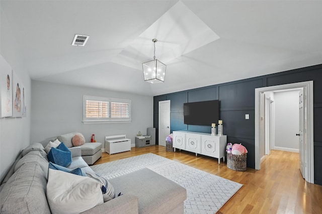 16905 Colegrove Dr, Dallas, TX 75248 - living room with light wood-style flooring, a chandelier, and a decorative wall