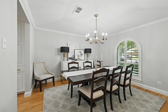 16905 Colegrove Dr, Dallas, TX 75248 - dining room featuring a chandelier, light wood finished floors, crown molding, and baseboards