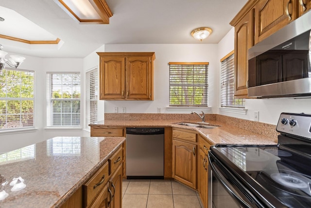 623 Madison Pl, Sherman, TX 75092 - kitchen featuring stainless steel appliances, brown cabinets, light tile patterned floors, a sink, and light stone counters