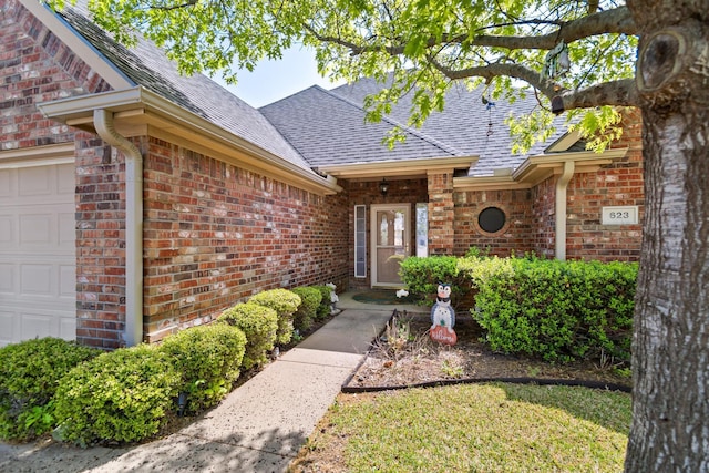 623 Madison Pl, Sherman, TX 75092 - entrance to property featuring an attached garage, a shingled roof, and brick siding