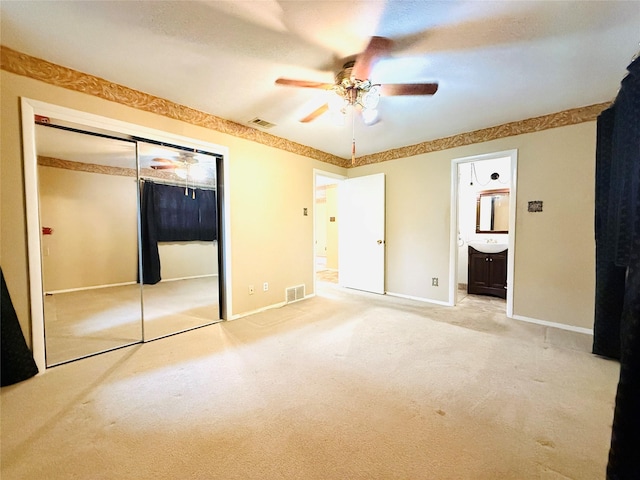1210 Carroll Dr, Garland, TX 75041 - unfurnished bedroom with a closet, carpet floors, baseboards, connected bathroom, and a ceiling fan