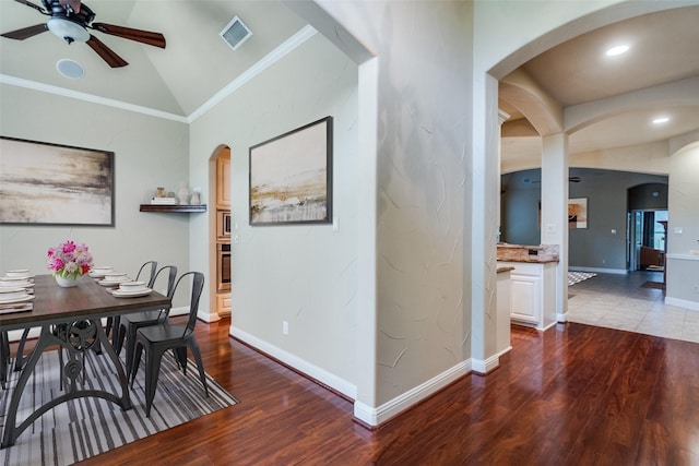 209 Pine Valley Ct, Fairview, TX 75069 - dining space featuring a ceiling fan, wood finished floors, arched walkways, vaulted ceiling, and crown molding