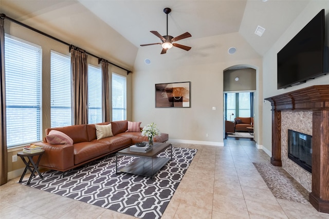 209 Pine Valley Ct, Fairview, TX 75069 - tiled living area with healthy amount of natural light, ceiling fan, a tile fireplace, lofted ceiling, and arched walkways