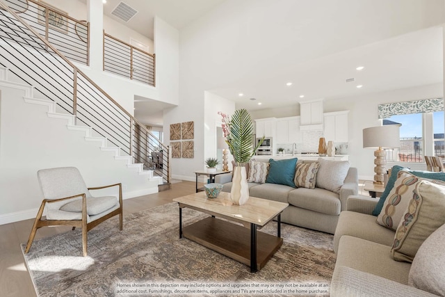 4622 Bel Air Dr, Midlothian, TX 76065 - living room with stairway, baseboards, wood finished floors, recessed lighting, and a high ceiling