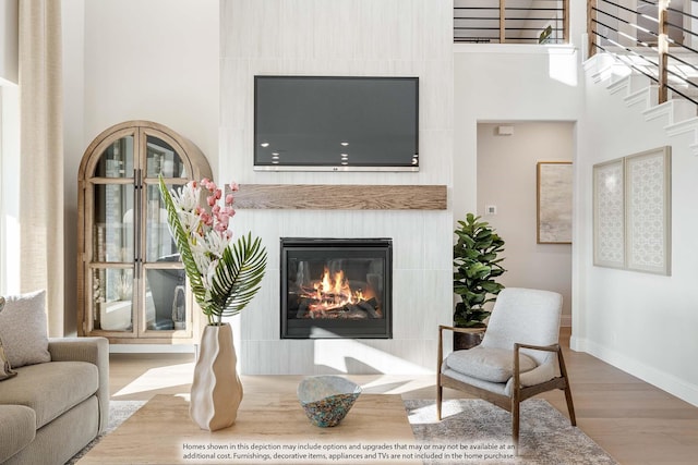 4622 Bel Air Dr, Midlothian, TX 76065 - living room featuring wood finished floors, a glass covered fireplace, baseboards, and a towering ceiling