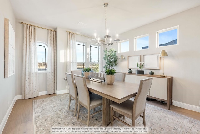 4622 Bel Air Dr, Midlothian, TX 76065 - dining room with a chandelier, light wood-style flooring, and baseboards