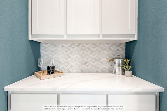 4622 Bel Air Dr, Midlothian, TX 76065 - kitchen featuring tasteful backsplash, white cabinetry, a textured wall, and light stone counters