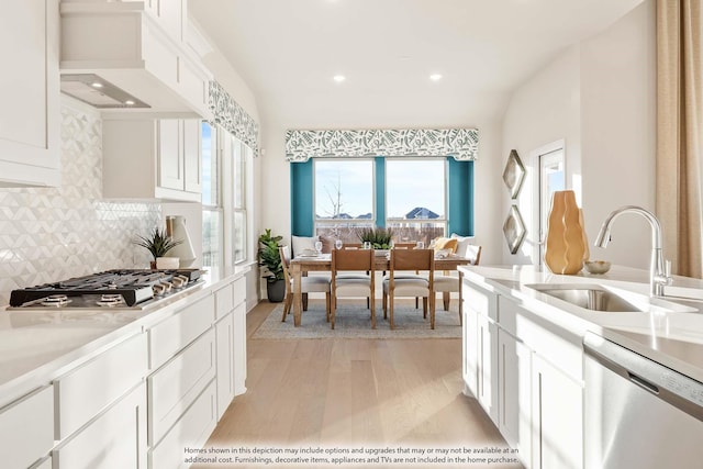 4622 Bel Air Dr, Midlothian, TX 76065 - kitchen featuring a sink, stainless steel appliances, light wood-type flooring, tasteful backsplash, and light countertops
