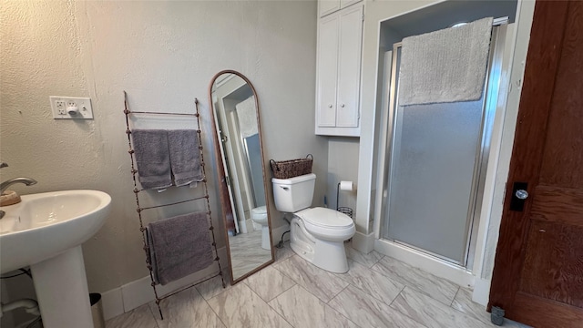 573 S Preston Ave, Van Alstyne, TX 75495 - bathroom with toilet, a shower stall, and marble look tile flooring