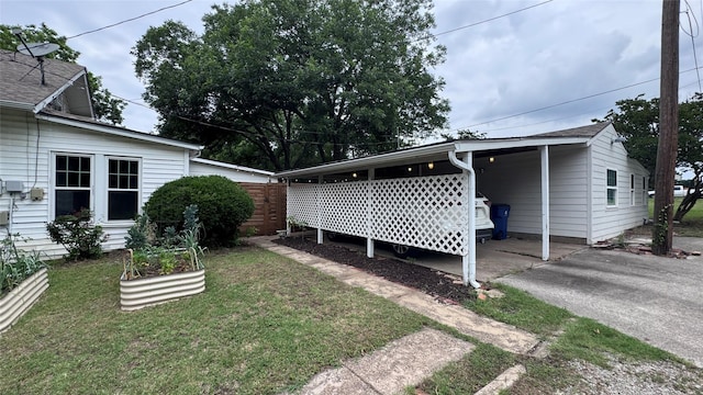 573 S Preston Ave, Van Alstyne, TX 75495 - view of green lawn featuring asphalt driveway and an attached carport