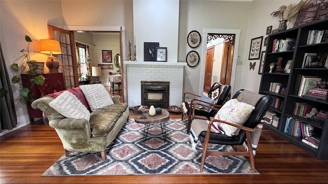 573 S Preston Ave, Van Alstyne, TX 75495 - living room with wood finished floors and a brick fireplace