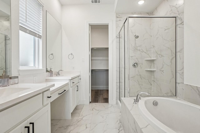 422 Firecrest Ln, Celina, TX 75009 - bathroom featuring marble finish floors, two vanities, a marble finish shower, a garden tub, and a spacious closet