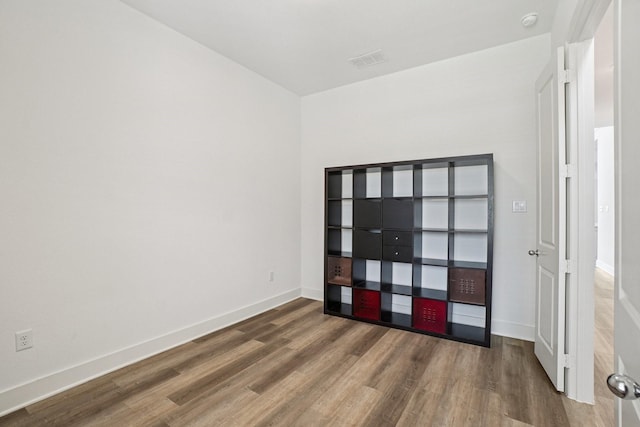 422 Firecrest Ln, Celina, TX 75009 - empty room featuring wood finished floors, baseboards, and a smoke detector