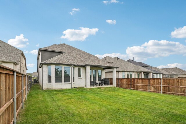 422 Firecrest Ln, Celina, TX 75009 - rear view of house featuring a patio area, brick siding, and roof with shingles