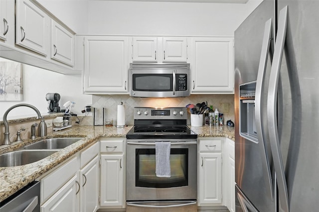 211 Cimarron Trl Unit 8, Irving, TX 75063 - kitchen with appliances with stainless steel finishes, a sink, and white cabinetry
