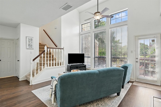 211 Cimarron Trl Unit 8, Irving, TX 75063 - living room with stairs, dark wood finished floors, ceiling fan, and baseboards