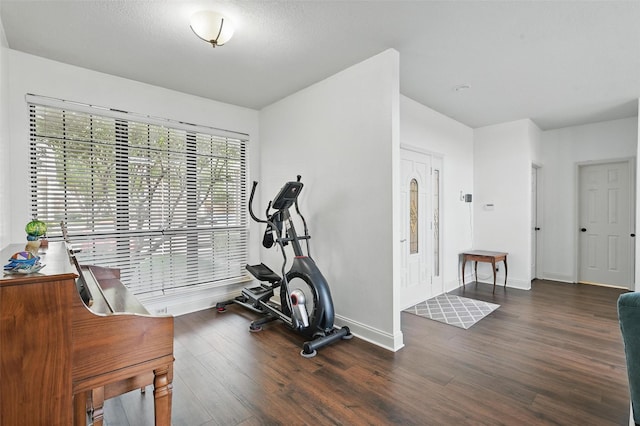 211 Cimarron Trl Unit 8, Irving, TX 75063 - exercise room with wood finished floors and baseboards