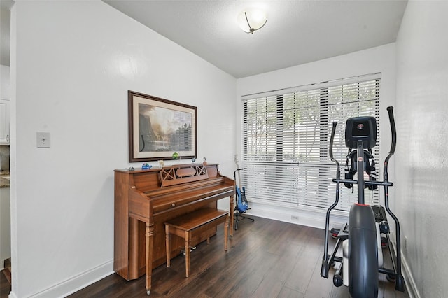 211 Cimarron Trl Unit 8, Irving, TX 75063 - workout area featuring baseboards and dark wood-style floors