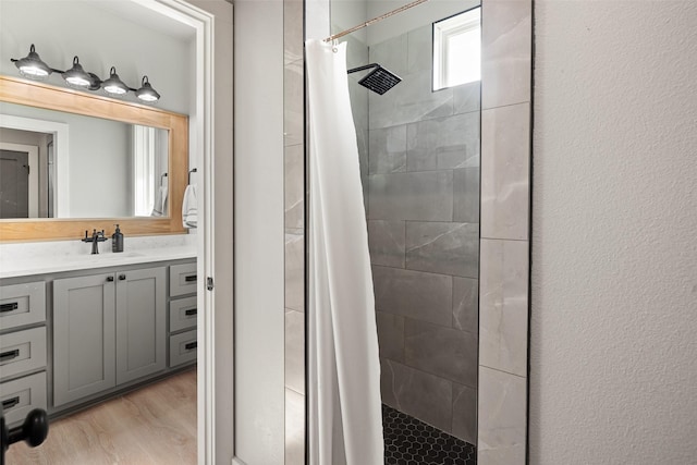 100 Tall Grass Ct, Weatherford, TX 76087 - full bathroom featuring tiled shower, vanity, and wood finished floors