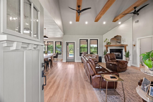 100 Tall Grass Ct, Weatherford, TX 76087 - living room with a ceiling fan, high vaulted ceiling, light wood finished floors, a fireplace, and beamed ceiling