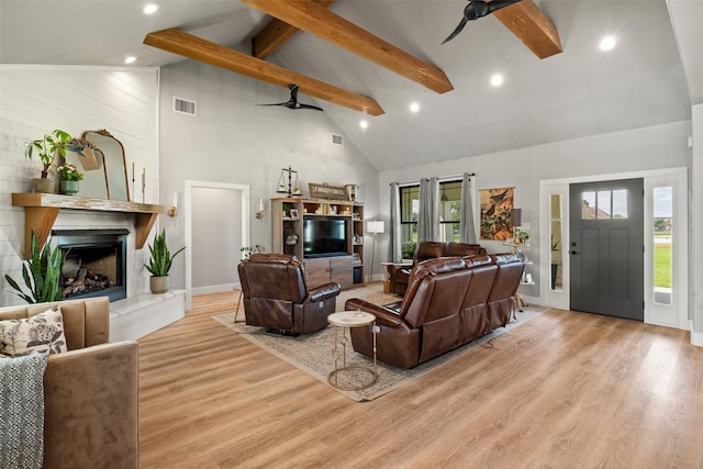 100 Tall Grass Ct, Weatherford, TX 76087 - living area featuring high vaulted ceiling, ceiling fan, beam ceiling, wood finished floors, and a large fireplace