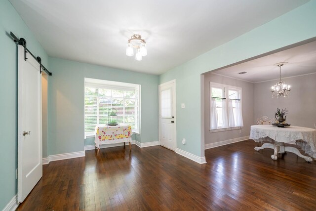 405 Houston St, Sulphur Springs, TX 75482 - foyer entrance with a chandelier, a barn door, baseboards, and hardwood / wood-style floors