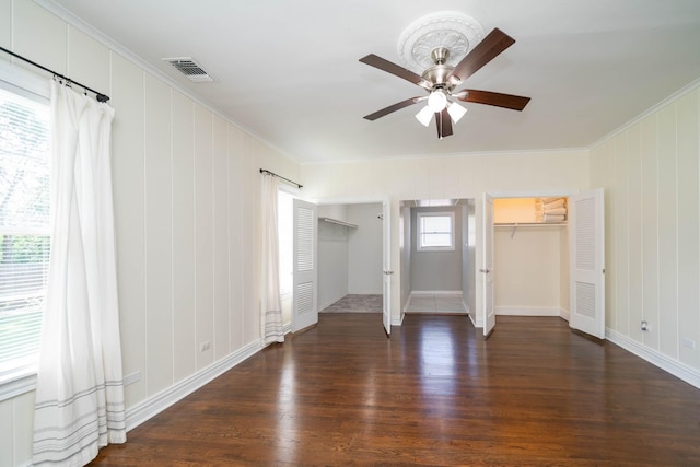 405 Houston St, Sulphur Springs, TX 75482 - unfurnished bedroom with ornamental molding, wood finished floors, two closets, baseboards, and ceiling fan