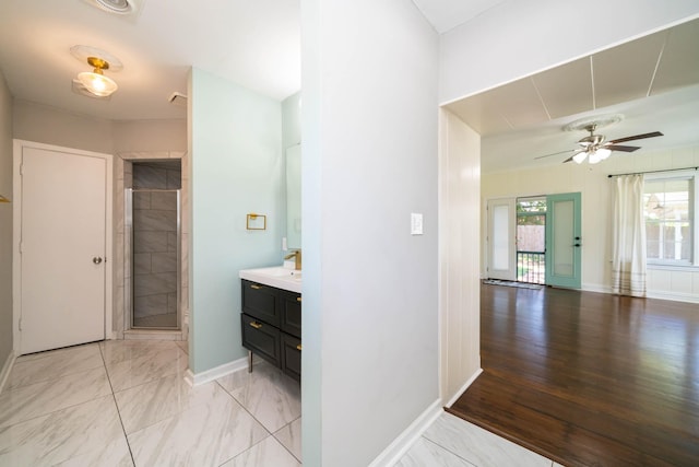 405 Houston St, Sulphur Springs, TX 75482 - full bathroom featuring vanity, a stall shower, baseboards, and a ceiling fan