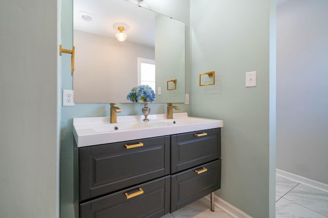 405 Houston St, Sulphur Springs, TX 75482 - bathroom with marble look tile flooring, double vanity, and baseboards