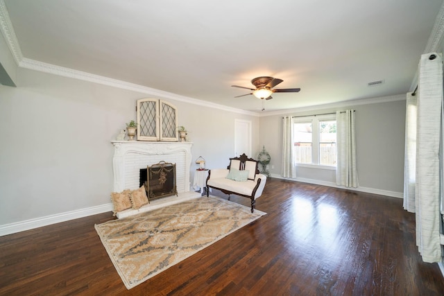 405 Houston St, Sulphur Springs, TX 75482 - living area featuring a ceiling fan, baseboards, wood finished floors, a brick fireplace, and crown molding