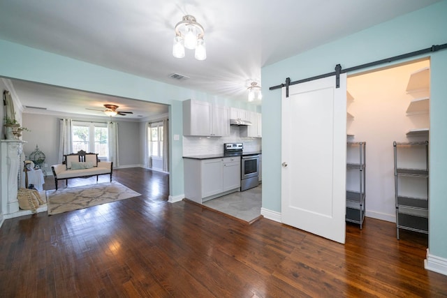 405 Houston St, Sulphur Springs, TX 75482 - kitchen featuring stainless steel electric stove, a barn door, wood finished floors, open floor plan, and white cabinetry