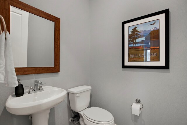 4860 Connor Pl, Fairview, TX 75069 - half bathroom featuring toilet, a sink, and baseboards