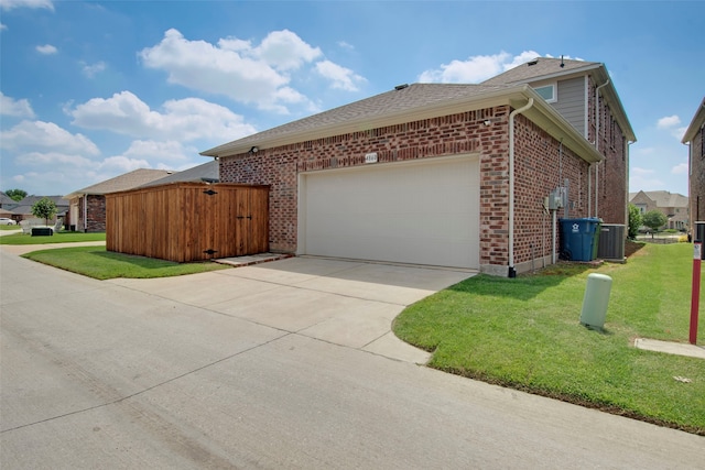 4860 Connor Pl, Fairview, TX 75069 - view of side of home featuring concrete driveway, a yard, an attached garage, brick siding, and central AC