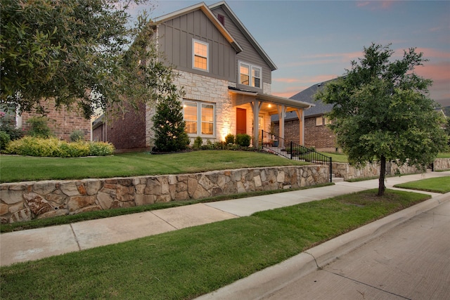 4860 Connor Pl, Fairview, TX 75069 - view of front of home with stone siding, board and batten siding, and a front yard