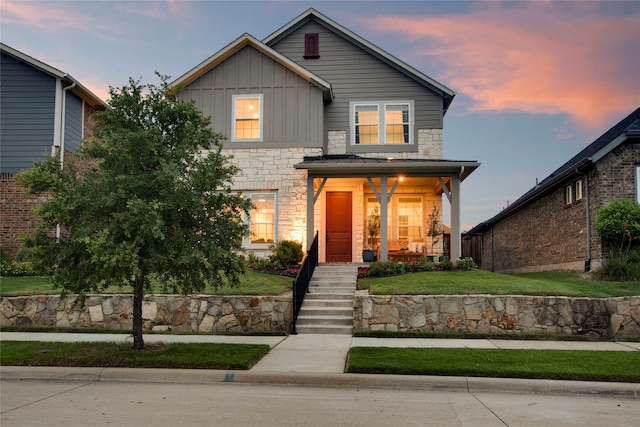 4860 Connor Pl, Fairview, TX 75069 - traditional-style home featuring board and batten siding, stone siding, a front lawn, and covered porch