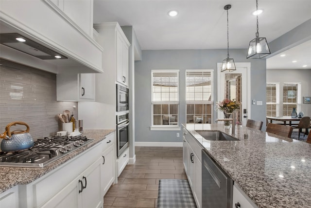 4860 Connor Pl, Fairview, TX 75069 - kitchen with a sink, appliances with stainless steel finishes, tasteful backsplash, white cabinets, and pendant lighting