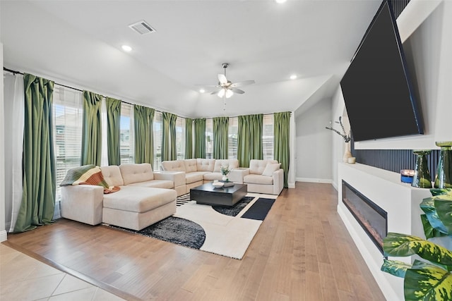 801 Dove Haven Ln, Melissa, TX 75454 - living area with a ceiling fan, a glass covered fireplace, baseboards, light wood-style floors, and recessed lighting