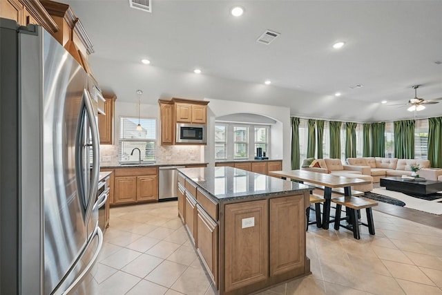 801 Dove Haven Ln, Melissa, TX 75454 - kitchen with appliances with stainless steel finishes, open floor plan, a sink, a center island, and tasteful backsplash