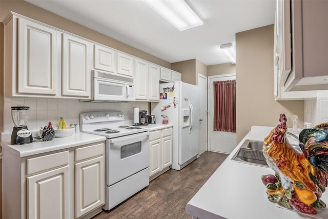 1202 Rice Rd Unit 122, Tyler, TX 75703 - kitchen with white appliances, tasteful backsplash, dark wood-style floors, white cabinets, and light countertops
