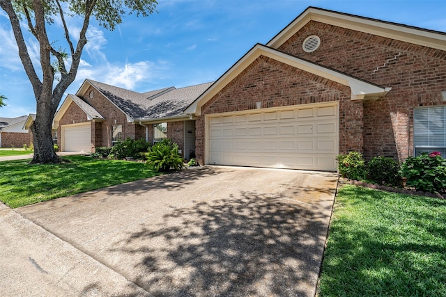 1202 Rice Rd Unit 122, Tyler, TX 75703 - view of front of property featuring a garage, concrete driveway, brick siding, and a front yard