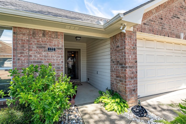 1202 Rice Rd Unit 122, Tyler, TX 75703 - property entrance with brick siding, an attached garage, and a shingled roof