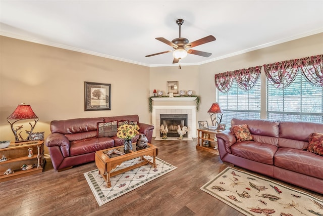 1202 Rice Rd Unit 122, Tyler, TX 75703 - living room featuring a ceiling fan, ornamental molding, dark wood-type flooring, and a tiled fireplace