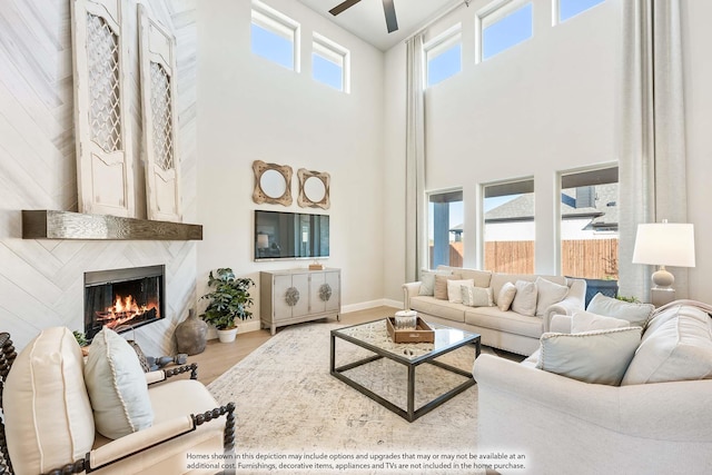 4410 Biscayne Dr, Midlothian, TX 76065 - living area with a high ceiling, a high end fireplace, a ceiling fan, wood finished floors, and baseboards