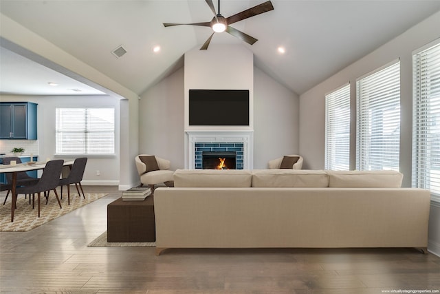 1110 Howley Ct, Forney, TX 75126 - living room with a ceiling fan, baseboards, wood finished floors, a tile fireplace, and lofted ceiling